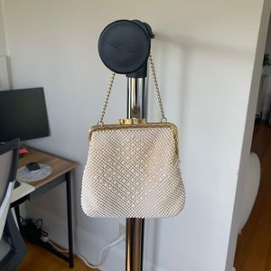 Vintage cream colored clutch purse with gold chain strap.